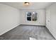 Bright bedroom with grey carpet and large window at 8508 Quarton Dr, Raleigh, NC 27616