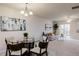 Open concept dining area with glass table and seating for four at 100 Stratford Lakes Dr # 306, Durham, NC 27713