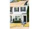 Two-story townhome featuring neutral siding and landscaping at 100 Stratford Lakes Dr # 306, Durham, NC 27713