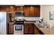 Well-equipped kitchen with dark wood cabinets and stainless steel appliances at 100 Stratford Lakes Dr # 306, Durham, NC 27713