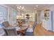 Bright dining area with a round wooden table and wicker chairs, adjacent to kitchen at 1008 Oakgate Ct, Apex, NC 27502