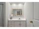 Bright bathroom with a white vanity and large mirror at 108 Pointe Crest Ct, Cary, NC 27513