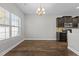 Kitchen and dining room with hardwood floors and dark cabinetry at 1219 Shining Water Ln, Creedmoor, NC 27522