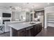 Modern kitchen with island, stainless steel appliances, and hardwood floors at 1833 Hydrangea Way, Fuquay Varina, NC 27526