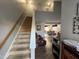 View of staircase leading to upper level, showing spacious living area beyond at 2320 Spruce Shadows Ln, Raleigh, NC 27614