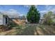 Spacious backyard with raised garden beds and mature trees at 2434 Orice St, Burlington, NC 27215