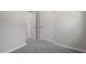 Hallway with two closed doors and neutral walls and carpet at 2612 Glenbrook Dr, Durham, NC 27704