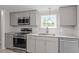 Modern kitchen featuring gray cabinets and granite countertops at 262 Homestead Dr, Selma, NC 27576