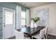 Bright dining room with dark wood table and white chairs near sliding glass door at 2782 Farmhouse Dr, Apex, NC 27502
