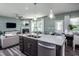 Open concept kitchen with island, stainless steel appliances, and view into living room at 2782 Farmhouse Dr, Apex, NC 27502