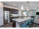 Modern kitchen with dark cabinetry, granite island, and stainless steel appliances at 2782 Farmhouse Dr, Apex, NC 27502