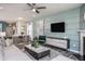 Open concept living room with sectional sofa, fireplace, and built-in media console at 2782 Farmhouse Dr, Apex, NC 27502