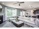 Spacious living room with sectional sofa, fireplace, and large window at 2782 Farmhouse Dr, Apex, NC 27502