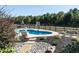 Inviting kidney-shaped pool with a basketball hoop and plenty of space to relax at 297 Denvale Dr, Selma, NC 27576