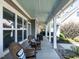 Relaxing covered porch with wicker seating and view of the backyard at 297 Denvale Dr, Selma, NC 27576