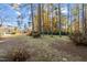 Spacious backyard with mature trees and grassy area at 3213 Courtney Ln, Sanford, NC 27330