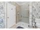 Spa-like bathroom with a walk-in shower, patterned wallpaper, and modern fixtures at 4027 Green Forest Ct, Rocky Mount, NC 27804
