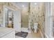 Modern bathroom with a walk-in shower, toilet and patterned wallpaper at 4027 Green Forest Ct, Rocky Mount, NC 27804
