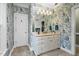 Elegant bathroom with patterned wallpaper, a vanity with ample storage, and a large mirror at 4027 Green Forest Ct, Rocky Mount, NC 27804