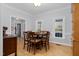 Dining room features hardwood floors, a round table and view into entryway at 4027 Green Forest Ct, Rocky Mount, NC 27804