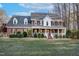 Brick two-story house with a large front porch and well-maintained lawn at 4027 Green Forest Ct, Rocky Mount, NC 27804