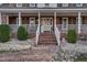 Brick walkway leads to a charming front porch with white railings at 4027 Green Forest Ct, Rocky Mount, NC 27804