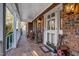 Front porch with rocking chairs, brick flooring, and white railings at 4027 Green Forest Ct, Rocky Mount, NC 27804