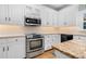 Stainless steel appliances and white cabinetry highlight this kitchen at 4027 Green Forest Ct, Rocky Mount, NC 27804