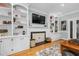 Living room boasts built-in shelving, fireplace, hardwood floors and large TV at 4027 Green Forest Ct, Rocky Mount, NC 27804