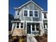 Two-story home with gray siding, stone accents, and a dark green door at 432 La Maison Ave # 13, Wendell, NC 27591