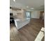 Open concept kitchen with island, stainless steel appliances, and hardwood floors at 432 La Maison Ave # 13, Wendell, NC 27591