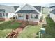 Gray house with red door and wooden walkway at 443 Anna St, Lillington, NC 27546