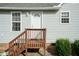 Rear view of house with wooden stairs and landscaping at 443 Anna St, Lillington, NC 27546