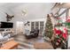 Living room featuring a Christmas tree, comfy seating, and wood floors at 4433 Spoon Loop Loop, Liberty, NC 27298