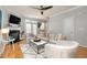 Living room with white sofas, fireplace, and hardwood floors at 4618 Merendino St, Raleigh, NC 27606