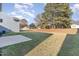 Spacious backyard with a large grassy area and patio at 62 Tanglewood Pl, Angier, NC 27501