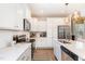 Modern kitchen with white cabinets, stainless steel appliances, and a large island at 62 Tanglewood Pl, Angier, NC 27501