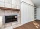 Modern fireplace with tile surround and wood mantel at 6625 Suburban Dr, Raleigh, NC 27615