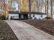 Modern house exterior with a pergola and long driveway at 6625 Suburban Dr, Raleigh, NC 27615