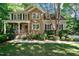 Two-story house with stone accents and landscaped yard at 7061 Landingham Dr, Willow Springs, NC 27592