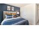 Spacious bedroom with a blue and white striped comforter and blue accent wall at 8654 Brixton Shay Dr, Raleigh, NC 27616