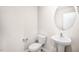 Clean bathroom with pedestal sink and oval mirror at 8656 Brixton Shay Dr, Raleigh, NC 27616