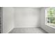 Spacious bedroom with neutral carpeting and a window at 8656 Brixton Shay Dr, Raleigh, NC 27616