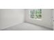 Well-lit bedroom with neutral carpeting and a window at 8656 Brixton Shay Dr, Raleigh, NC 27616