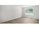 Bright bonus room with wood-look flooring and large window at 8656 Brixton Shay Dr, Raleigh, NC 27616