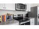 Kitchen detail showing cooktop, microwave, and granite countertop at 8656 Brixton Shay Dr, Raleigh, NC 27616