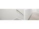 Image of a carpeted staircase with a wooden handrail at 8656 Brixton Shay Dr, Raleigh, NC 27616