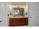 Double vanity bathroom with updated fixtures and a large mirror at 920 Chapanoke Rd, Raleigh, NC 27603