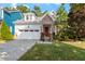 Brick and white two-story house with a red door and attached garage at 920 Chapanoke Rd, Raleigh, NC 27603