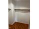 Large walk-in closet with wood shelving and rod at 6232 Dawn Dr, Hurdle Mills, NC 27541